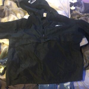 A champion windbreaker, size Medium with a hood drawstring attached